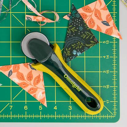 Omnigrid cutting mats include rotary, double-sided, foldaway pressing station and quilting travel kits.  