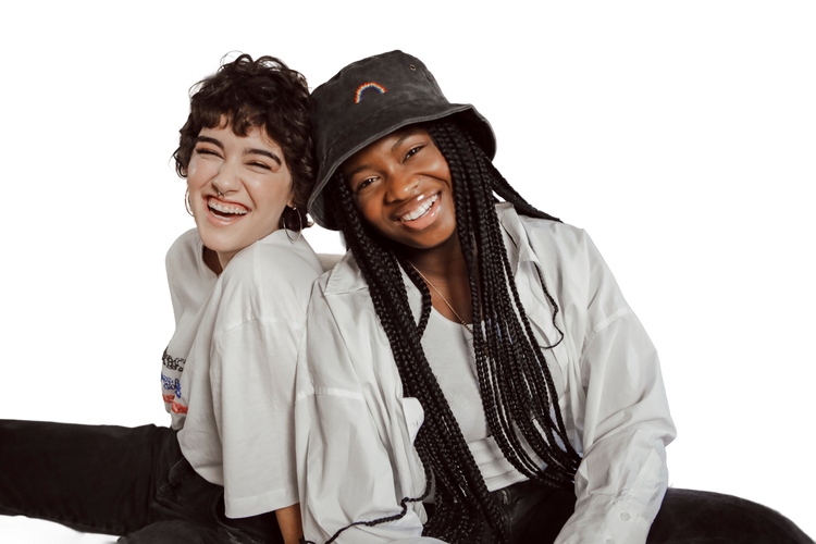 Two people smiling, sitting together wearing handcrafted items
